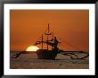 A Man And An Outrigger Silhouetted Against A Brilliant Orange Sky by Paul Chesley Limited Edition Print