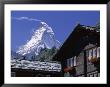 The Peak Of The Matterhorn Mountain Towering Above Chalet Rooftops, Swiss Alps, Switzerland by Ruth Tomlinson Limited Edition Print