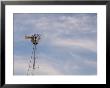A Windmill Stands Tall Against A Cloudy Sky At Steven's Creek Farm by Joel Sartore Limited Edition Print