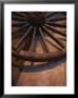 Close-Up Of Wooden Wagon Wheel Lit By Setting Sun by Todd Gipstein Limited Edition Print