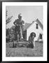 Young Boy Mowing The Lawn With A Simple Mower While His Dog Follows by Myron Davis Limited Edition Print