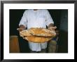 A Baker Shows His Fresh Loaves In The Village Bakery by Heather Perry Limited Edition Print