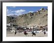 Game Of Polo On Leh Polo Field, Tsemo Gompa On Ridge Behind, Leh, Ladakh, India by Tony Waltham Limited Edition Print