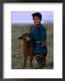Boy Wearing Traditional Dell Standing Next To Baby Goat, Mongolia by Jerry Galea Limited Edition Print