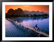 People Crossing Bridge Across Nam Song River By Motorbike, Vang Vieng, Laos by John Elk Iii Limited Edition Print