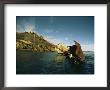 A Partially Submerged Shipwreck Along A Rocky Shore by Bill Curtsinger Limited Edition Print