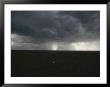 Sunlight Streams Through An Opening In Storm Clouds During A Downpour by Randy Olson Limited Edition Print