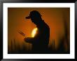 Silhouetted Botanist Examining Grain by Steve Raymer Limited Edition Pricing Art Print