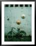 Conical Hats Hang On Wall Above Bicycle In Historic Old Quarter, Hanoi, Vietnam by Richard I'anson Limited Edition Print