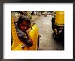 Taxi Driver Leaning Out Window As Motor Rickshaw Goes Past, Chowringee, India by Anthony Plummer Limited Edition Print