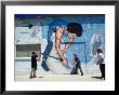 Boys Playing Cricket In Front Of Mural Wall On The Elliston Community Hall., Elliston, Australia by Greg Elms Limited Edition Print