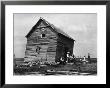 Ramshackle Barn With Farmer And Kids In Front Sharpening A Sickle Blade During Drought In Midwest by Margaret Bourke-White Limited Edition Print