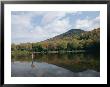 A Fisherman And His Reflection Are Surrounded By The Colors Of Fall by Richard Nowitz Limited Edition Pricing Art Print