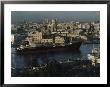 City And A Massive Freighter As It Cruises The Canal, Havana, Cuba by James L. Stanfield Limited Edition Pricing Art Print
