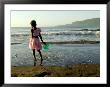 A Girl Walks On The Beach In Jacmel, Haiti, In This February 5, 2001 by Lynne Sladky Limited Edition Pricing Art Print