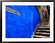 Young Women Decending Stairs Outside Blue Painted Casa Mona In Zona Centro, Puerto Vallarta, Mexico by Anthony Plummer Limited Edition Pricing Art Print
