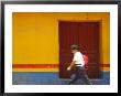 Schoolboy Running Past Wooden Door And Colorful Wall, Guatemala by Dennis Kirkland Limited Edition Pricing Art Print