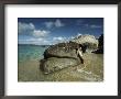 Young Woman Resting Against A Rock On A Pristine Beach by Bill Curtsinger Limited Edition Print