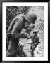 American Lieutenant Carrying Micronesian Baby He Found In Cave Japanese Soldiers Holed Up There by W. Eugene Smith Limited Edition Pricing Art Print