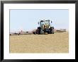 Tractor Rolling A Recently Ploughed Field Near Moreton-In-Marsh, England by Martin Page Limited Edition Print
