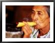 Woman Smokes Handmade Cheroot With Large Ashtray, Bagan, Myanmar (Burma) by Anthony Plummer Limited Edition Print