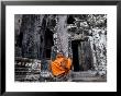 A Buddhist Monk Relaxes In The Bayon Temple, Angkor, Unesco World Heritage Site, Cambodia by Andrew Mcconnell Limited Edition Print