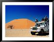 Men On Four Wheel Drive Vehicle At Dune 45 In Namib Nauklaft National Park, Sossusvlei, Namibia by Christer Fredriksson Limited Edition Print