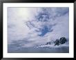 A Cloud-Filled Sky Over Mountains On The Antarctic Peninsula by Gordon Wiltsie Limited Edition Pricing Art Print