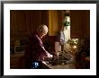 Sun Shines Down On An Older Male Washing Dishes In His Home by Joel Sartore Limited Edition Print