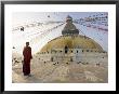 Young Buddhist Monk Turns To Look At The Dome Of Boudha Tibetan Stupa In Kathmandu, Asia by Don Smith Limited Edition Print