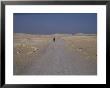 A Dark-Robed Egyptian Contrasted Against The Bright Desert Landscape Near Saqqara by Stephen St. John Limited Edition Print