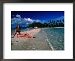 Woman Sunbathing On Sand Spit Of Snick Island, El Nido, Philippines by Mark Daffey Limited Edition Pricing Art Print