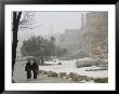 Two Priests Walk In Snow In Front Of The Jaffa Gate In Jerusalem's Old City, December 27, 2006 by Oded Balilty Limited Edition Print