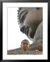 Young Boy In Front Of Giant Buddha At Ngong Ping Plateau, China by Holger Leue Limited Edition Print