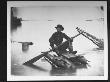 Union Officer Holding Oar And Sitting On Makeshift Raft Used For Scouting Operations, Civil War by Andrew Joseph Russell Limited Edition Print