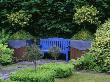 Blue Bench With Lead And Rusty Metal Containers Planted With Holly And Box, Designer: Tony Ridler by Clive Nichols Limited Edition Print