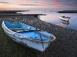 Small Boats In Poole Harbour At Dawn, One Pulled Up On The Muddy Beach. Dorset, England by Adam Burton Limited Edition Print