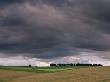 Thunder Clouds In Sky Over A Distant Row Of Trees On The South Downs, Hampshire, Uk by Adam Burton Limited Edition Print