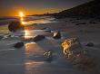 Early Morning Sunshine On Sandstone Boulders, Dunstanburgh Beach, Northumberland, England by Adam Burton Limited Edition Print