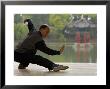 Man Doing Tai Chi Exercises At Black Dragon Pool With One-Cent Pavilion, Lijiang, China by Pete Oxford Limited Edition Print