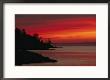 A Bright Red Sky Over Lake Superior At Dawn With Silhouettes Of The Rocky Coast by Maria Stenzel Limited Edition Print