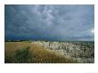 Storm Clouds Gather Over The Southern Unit Of South Dakotas Badlands by Annie Griffiths Belt Limited Edition Print