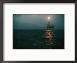 Night View Of A Plume Of Fire From An Offshore Oil Rig In This Norwegian Oil Field by Emory Kristof Limited Edition Print