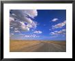 Cumulus Clouds Above A Dirt Road On A Wyoming Prairie by John Eastcott & Yva Momatiuk Limited Edition Print