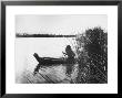 Pomo Indian Poling His Boat Made Of Tule Rushes Through Shallows Of Clear Lake, Northen California by Edward S. Curtis Limited Edition Print