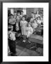 Children Reciting The Pledge Of Allegiance As A Boy Holds The Us Flag In Their Classroom by Bernard Hoffman Limited Edition Print