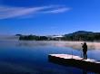 Photographer On Pier Of Lake Superior Near Mount Tremblant, Quebec, Canada by Alain Evrard Limited Edition Print