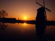 Silhouette Of A Windmill At Sunset by Fogstock Llc Limited Edition Print