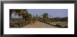 Two Monks Walking In Front Of An Old Temple, Angkor Wat, Siem Reap, Cambodia by Panoramic Images Limited Edition Print