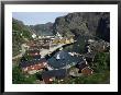 Wooden Red Houses On Stilts Over Water At The Fishing Village Of Nusfjord, Lofoten Islands, Norway by Tony Waltham Limited Edition Print